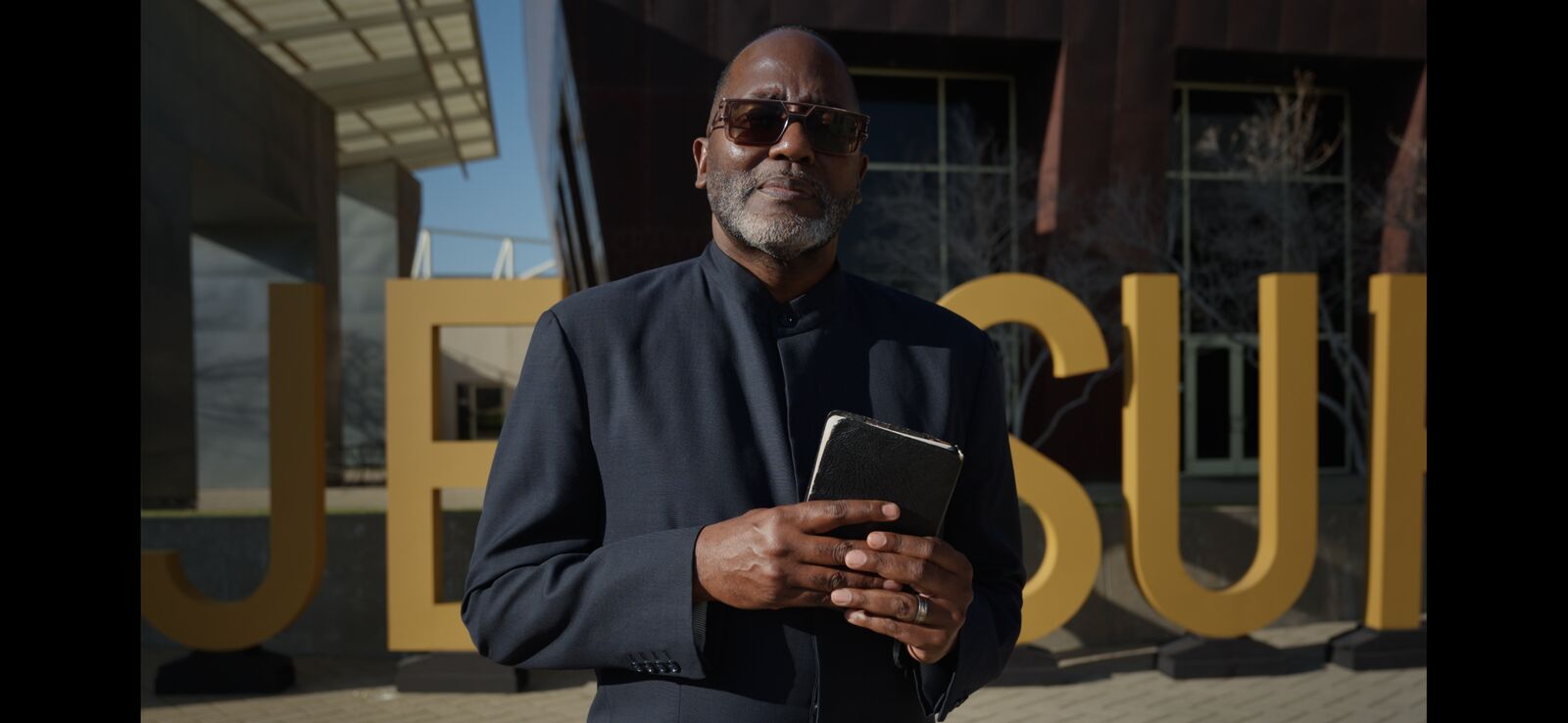 Speaker standing in front of the Jessup University wordmark