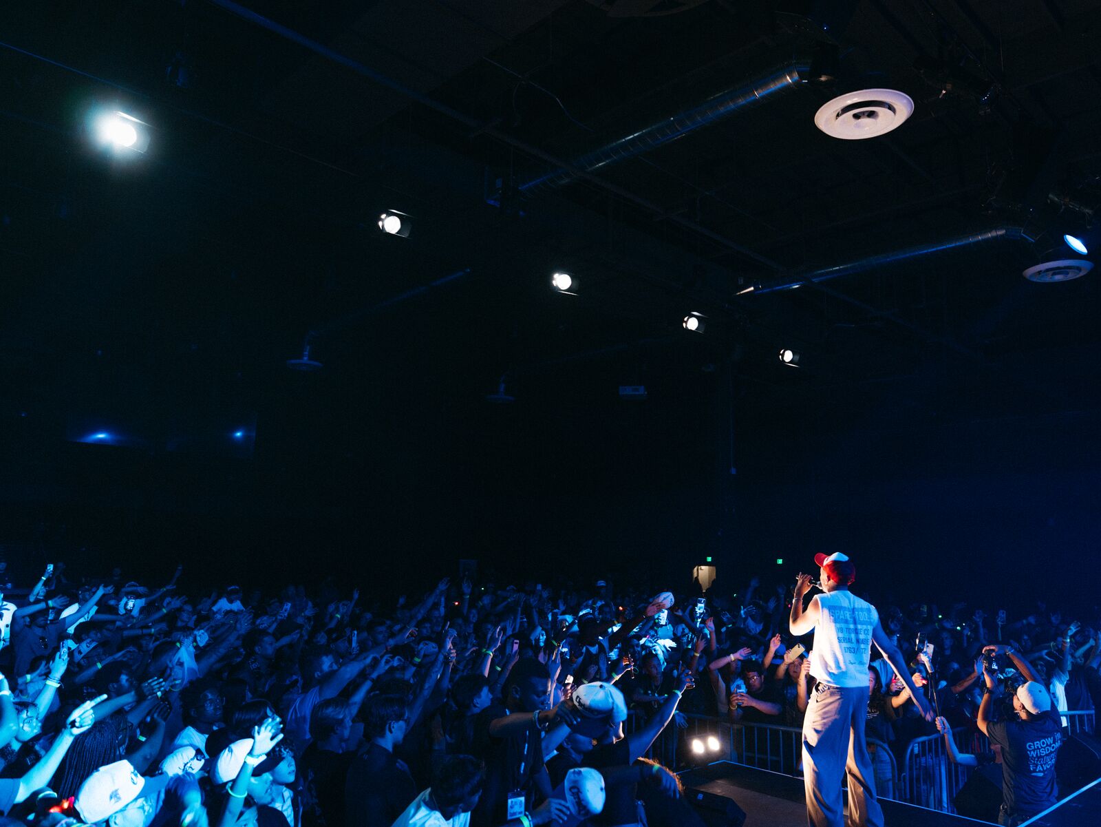 Wide view of Miles Minnick performing before a full audience
